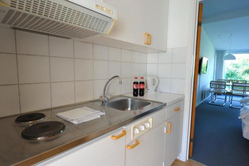 a kitchen with a sink and a counter top at Hotel Balka Strand in Neksø