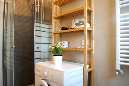 a bathroom with a washer and dryer on a shelf at Bnbook - Metropolitan Expo Flat 4 in Rho