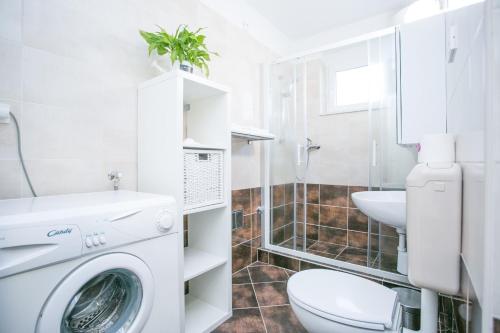 a bathroom with a washing machine and a sink at Modern Living in the Heart of Trogir in Trogir