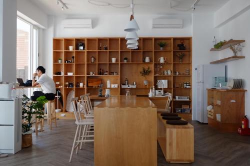 a man sitting at a table in a kitchen at Lof/it in Taitung City