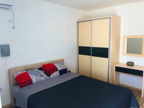 a bedroom with a bed with red roses on it at Vila Jovana in Sutomore