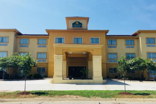 a building with a clock on top of it at La Quinta by Wyndham Fort Smith in Massard