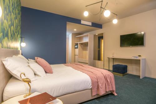 a bedroom with a bed and a desk and a tv at Priska Med Luxury Rooms in Split