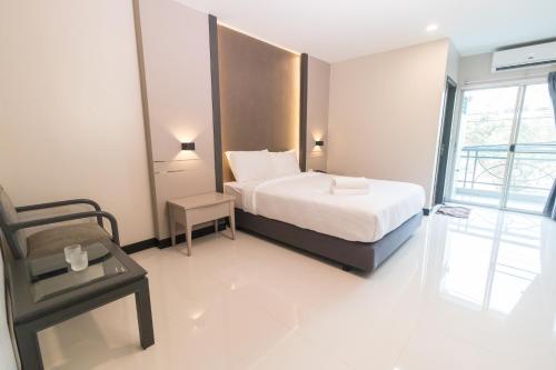 
a hotel room with a bed and a desk at So good Hotel Bangkok in Bangkok
