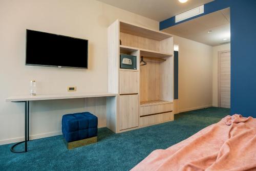 a room with a tv and a bed and a desk at Priska Med Luxury Rooms in Split