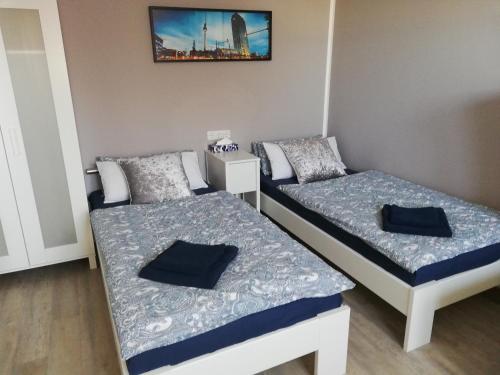 a room with two beds and a picture on the wall at Apartment mea in Berlin