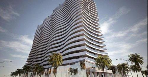 a large building with palm trees in front of it at PURE WELLNESS SEA-VIEW Beluga & Dolphin Luxury HOTEL apartments in Batumi