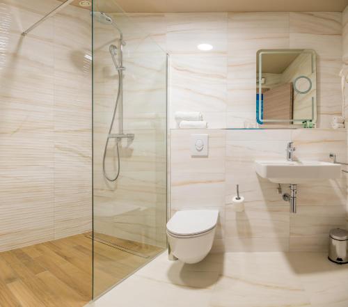 a bathroom with a shower and a toilet and a sink at Priska Med Luxury Rooms in Split