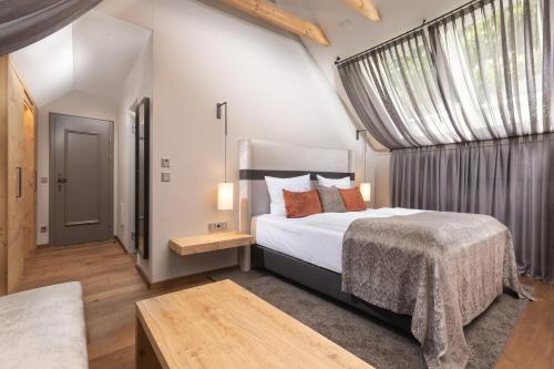 a bedroom with a king sized bed and a window at Hotel Goldene Sonne in Landshut