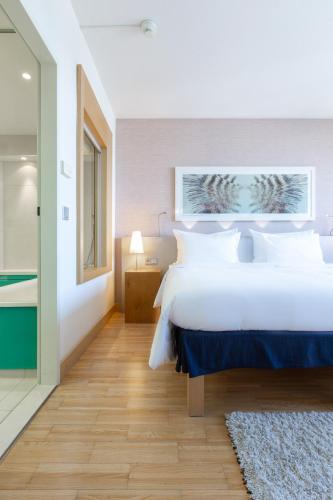 a bedroom with a large white bed and a window at Radisson Blu Hotel, Hamburg in Hamburg