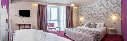 a hotel room with a bed and a bath tub at Priska Med Luxury Rooms in Split