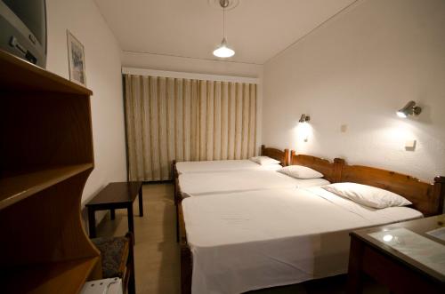 a row of four beds in a hotel room at Tropical Sol in Tigaki
