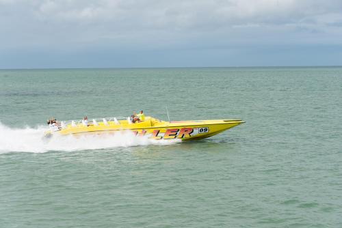 a yellow boat in the water with people on it at NEW 2bed2bath condo - CLEARWATER BEACH - FREE Wi-Fi and Parking in Clearwater