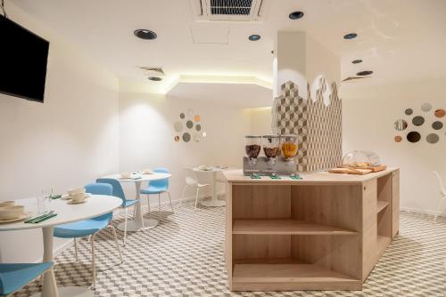 a restaurant with white tables and blue chairs at Priska Med Luxury Rooms in Split