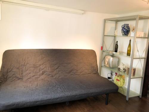 a couch in a room with a shelf at Hexenhäuschen Dreieichenhain in Dreieich