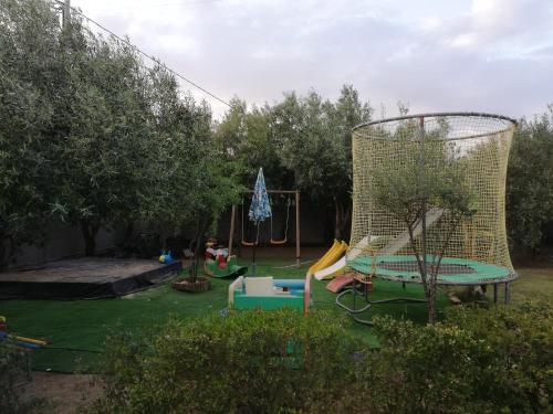 a backyard with a playground with a swing set at Villa REBECCA in Solanas