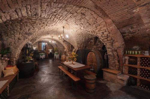 a wine cellar with a table and some wine barrels at Laubgassl in Mörbisch am See