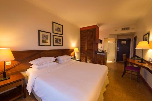 a bedroom with a large white bed and a desk at 254 Ole Sereni-Nairobi Park View in Nairobi