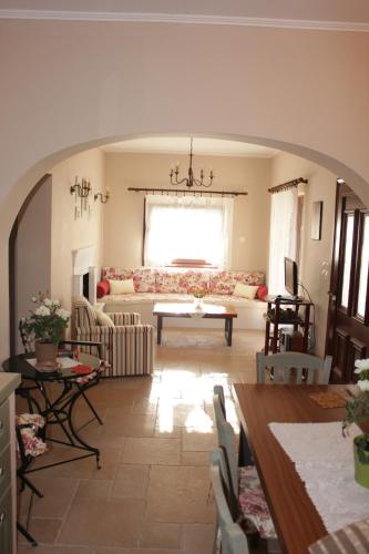 a living room with a couch and a table at *Villa Pap-Live the Greek hospitality in a village* in Néa Sampsoús