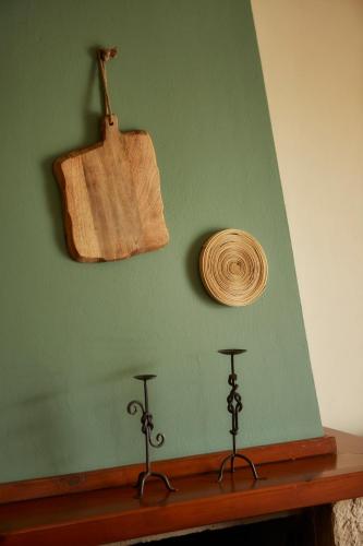 a green wall with a wooden spoon and a wooden object at Earino in Kato Asites
