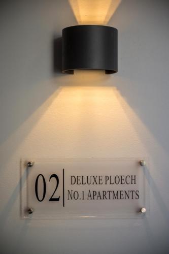 a light on a wall with a sign on it at Deluxe Ploech in Rijeka