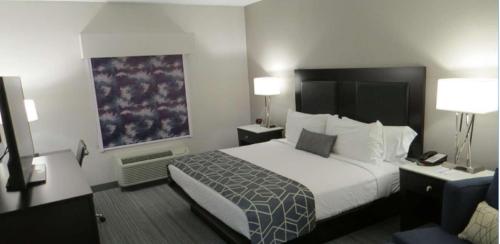 a hotel room with a bed and two lamps at Best Western Plus Wilkes Barre-Scranton Airport Hotel in Pittston