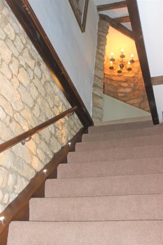 a set of stairs with a stone wall at Historic Grade II Listed Homely Cottage in Stamford