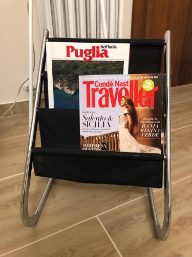 a chair with magazines on it on the floor at Holidays Lecce in Lecce