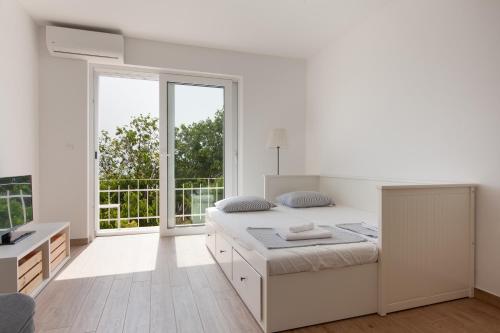 Una cama o camas en una habitación de Apartments Coast 27
