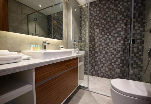 a bathroom with a sink and a shower at KeyHost - Regent Court JVC - K390 in Dubai