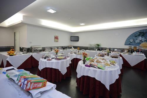 a banquet hall with tables with food on them at Hotel Relax Roma Nord in Fiano Romano