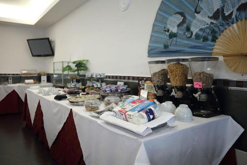 a group of tables with food and drinks on them at Hotel Relax Roma Nord in Fiano Romano
