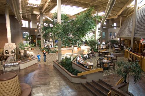 an empty mall with people sitting in tables and chairs at The Academy Hotel Colorado Springs in Colorado Springs