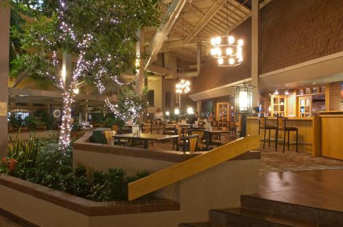 a restaurant with tables and chairs in a building at The Academy Hotel Colorado Springs in Colorado Springs