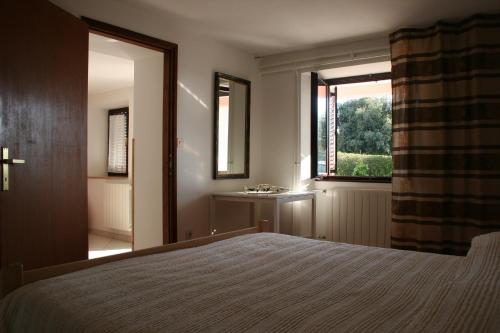 a bedroom with a bed and a window and a sink at Guest House Zohil in Rovinj