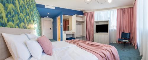 a bedroom with a large white bed and blue walls at Priska Med Luxury Rooms in Split