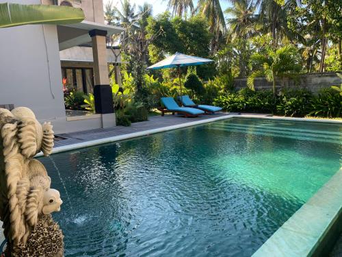 a swimming pool in front of a house at Pondok Ardi Villas in Tejakula