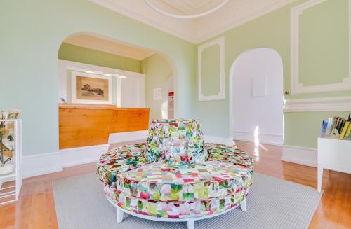 a living room with a colorful chair in the middle at Vila Recife Hotel in Albufeira