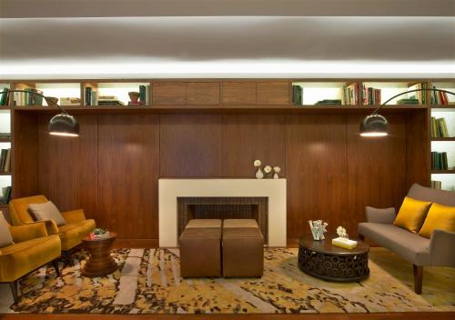 a living room with a couch and a fireplace at The Gardens Sonesta ES Suites New York in New York