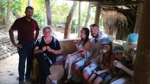 a group of people sitting on a couch at Jungle Village Homestay in Pinnawala