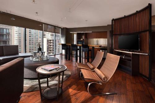 a living room with a couch and a table with chairs at Eurostars Magnificent Mile in Chicago
