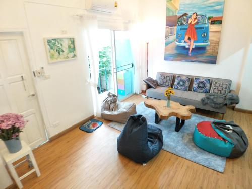 a living room with a couch and a table at Moon House in Chiang Mai