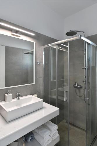 a bathroom with a sink and a glass shower at Efi Studios in Drios
