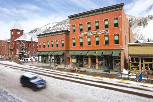 a car driving down a street in front of a building at New Sheridan Hotel in Telluride