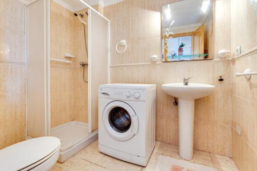 ein Badezimmer mit Waschmaschine und Waschbecken in der Unterkunft Apartamento Parquemar V in La Mata