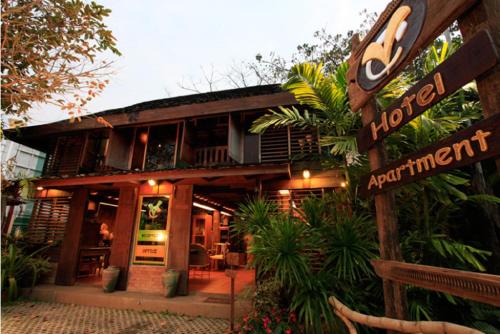 a hotel with a sign in front of it at VC@Suanpaak Boutique Hotel & Service Apartment in Chiang Mai