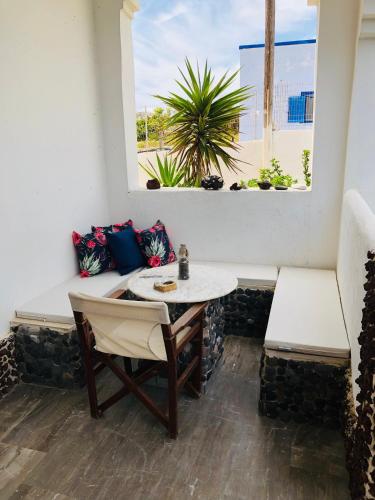 a table and chairs in a room with a window at Villa Livadaros in Karterados