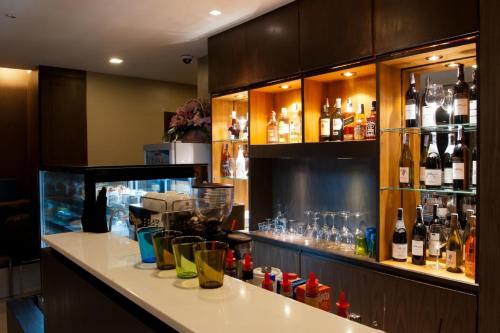 a bar with a lot of bottles of alcohol at 41 Suite Bangkok in Bangkok