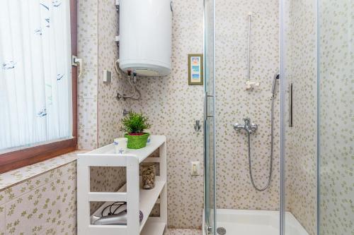 a bathroom with a shower and a sink at Holiday house Ledine -Kornić, Krk in Kornić