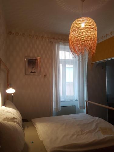 a bedroom with a bed and a chandelier at Garni Giacometti in Locarno